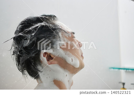 A man in his twenties taking a shower A man in his twenties taking a shower 140522321