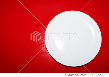 A red table with white plates A red table with white plates 140522333