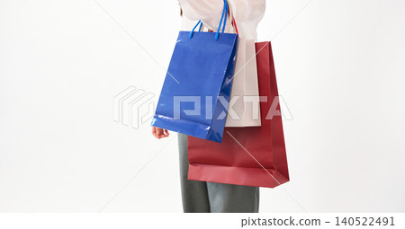 A young woman carrying many shopping bags. A young woman carrying many shopping bags. 140522491