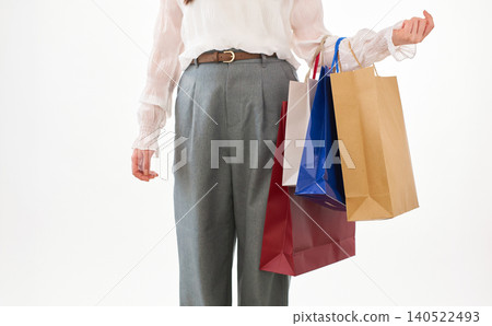 A young woman carrying many shopping bags. A young woman carrying many shopping bags. 140522493