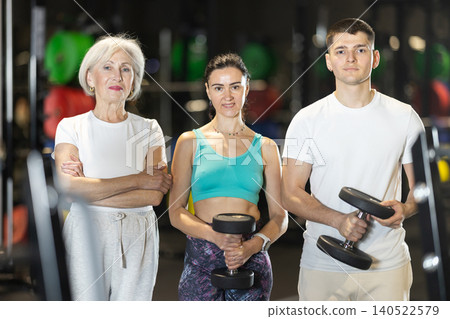 Sporty people of different ages standing in gym Sporty people of different ages standing in gym 140522579
