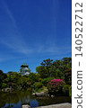 The majestic appearance of Osaka Castle, one of Japan's most famous castles, viewed from a Japanese garden. 140522712