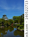 The majestic appearance of Osaka Castle, one of Japan's most famous castles, viewed from a Japanese garden. 140522713