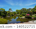 The majestic appearance of Osaka Castle, one of Japan's most famous castles, viewed from a Japanese garden. 140522715