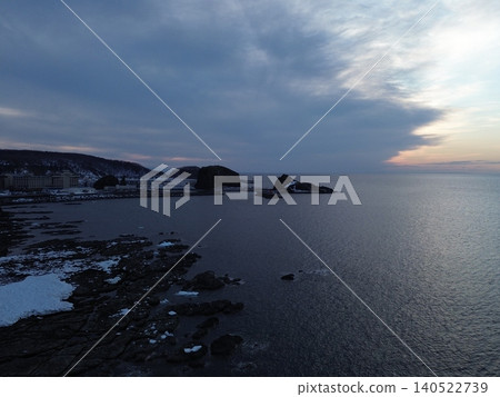 Aerial photograph of the sunset sky and sea from the coast of Utoro, where drift ice still remains. Aerial photograph of the sunset sky and sea from the coast of Utoro, where drift ice still remains. 140522739