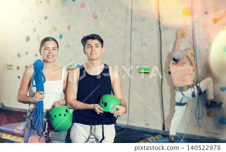 fitness instructors in gym discuss alpinist practice artificial rock climbing wall fitness instructors in gym discuss alpinist practice artificial rock climbing wall 140522978