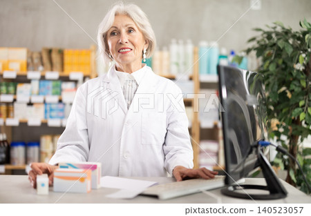 Elderly woman pharmacist invites customers to the pharmacy Elderly woman pharmacist invites customers to the pharmacy 140523057