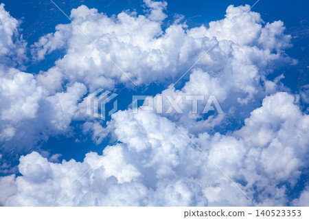 White cumulonimbus clouds spread across the blue sky above Japan. White cumulonimbus clouds spread across the blue sky above Japan. 140523353