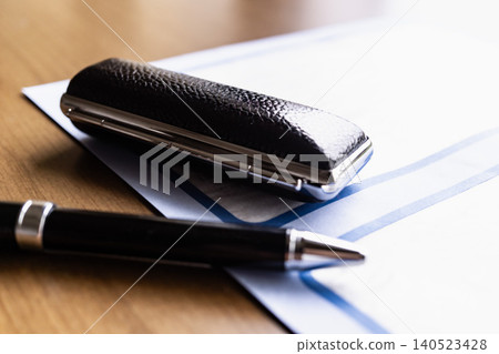 Documents, pen, and stamp on the desk; business background; work Documents, pen, and stamp on the desk; business background; work 140523428