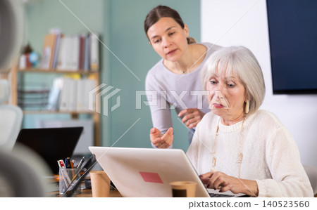 Boss help an older employee learn to use laptop Boss help an older employee learn to use laptop 140523560