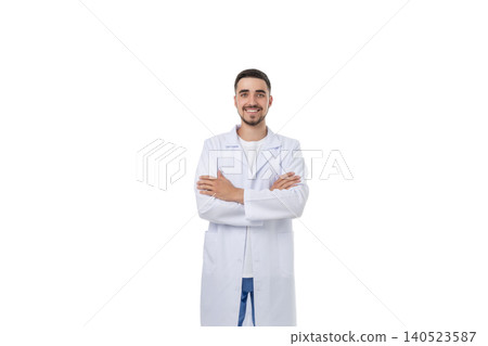 Doctor smiles confidently with arms crossed, on white 140523587