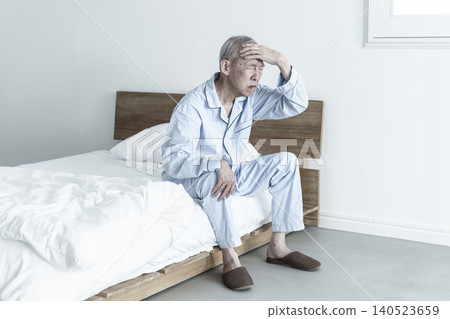 Elderly man holding his head Elderly man holding his head 140523659