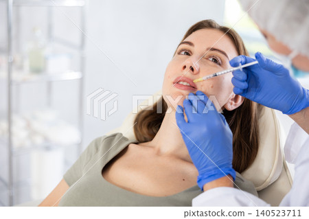 Facial injection young patient, closeup Facial injection young patient, closeup 140523711