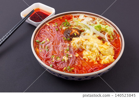Vibrant purple sweet potato noodles served in a rich tomato sauce, topped with eggs and fresh lettuce. Vibrant purple sweet potato noodles served in a rich tomato sauce, topped with eggs and fresh lettuce. 140523845