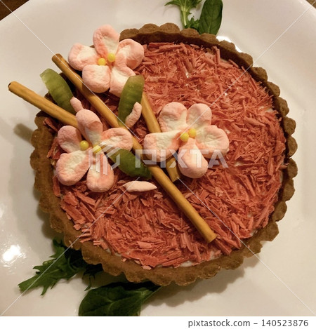 A chocolate tart topped with marshmallow cherry blossoms. A chocolate tart topped with marshmallow cherry blossoms. 140523876