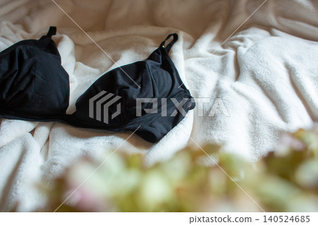 A black bra placed on the bed A black bra placed on the bed 140524685