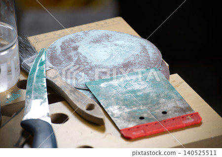 Paint Tools and Scrapers With Sandpaper Discs on Workshop Bench for DIY Home Renovation Paint Tools and Scrapers With Sandpaper Discs on Workshop Bench for DIY Home Renovation 140525511