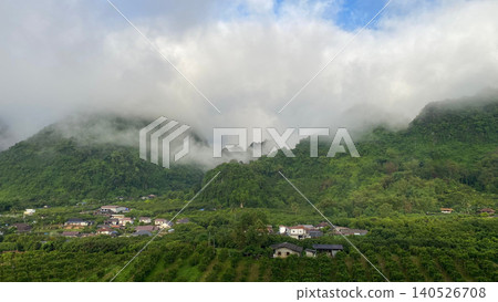 Misty Mountain Landscape Above Tropical Forest and Rural Village Misty Mountain Landscape Above Tropical Forest and Rural Village 140526708