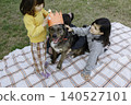 Children Celebrating Family Dog Birthday with Handmade Crown Outdoors 140527101