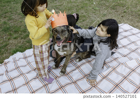 Children Celebrating Family Dog Birthday with Handmade Crown Outdoors Children Celebrating Family Dog Birthday with Handmade Crown Outdoors 140527101