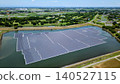 [Aerial view] Floating mega solar power plant on a reservoir and a rich rural landscape (Saitama Prefecture, Renewable Energy, SDGs) 140527115
