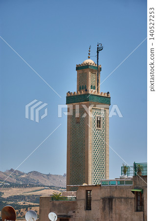 The minaret of the Great Mosque of Fes el-Jdid displays its traditional green tiles under the Moroccan sky 140527253
