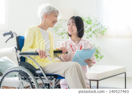 Smiling senior woman and care staff Smiling senior woman and care staff 140527463