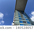 A view of buildings against a bright blue sky. 140528057