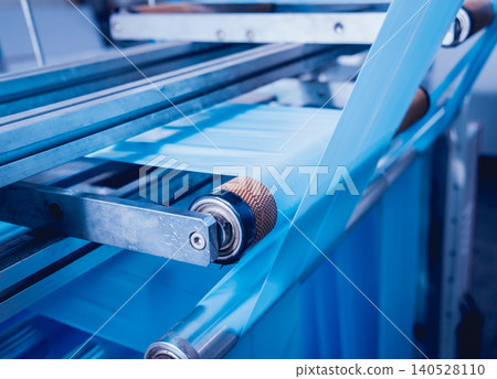 Modern automated production line in factory. Plastic bag manufacturing process Modern automated production line in factory. Plastic bag manufacturing process 140528110