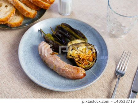 Fried sausages with grilled bell peppers and eggplant Fried sausages with grilled bell peppers and eggplant 140528719