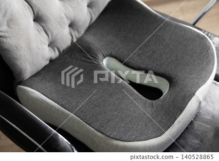 Gray ergonomic cushion with memory foam for chair, providing orthopedic support to coccyx and lumbar spine, promoting good posture Gray ergonomic cushion with memory foam for chair, providing orthopedic support to coccyx and lumbar spine, promoting good posture 140528865