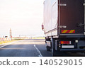 Rear view of white cargo truck on highway, semi-trailer traveling on asphalt road during bright day, transport vehicle moving away, logistics and delivery concept 140529015