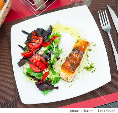 Salmon fillet with vegetables on a ceramic plate Salmon fillet with vegetables on a ceramic plate 140529022