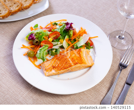 Salmon fillet with vegetables on a ceramic plate Salmon fillet with vegetables on a ceramic plate 140529115