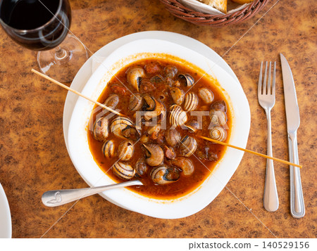 Delicious baked snails in bowl with salsa sauce Delicious baked snails in bowl with salsa sauce 140529156