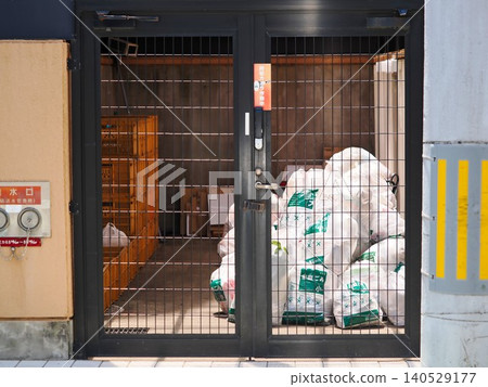 Garbage disposal area in an apartment building with a door Garbage disposal area in an apartment building with a door 140529177