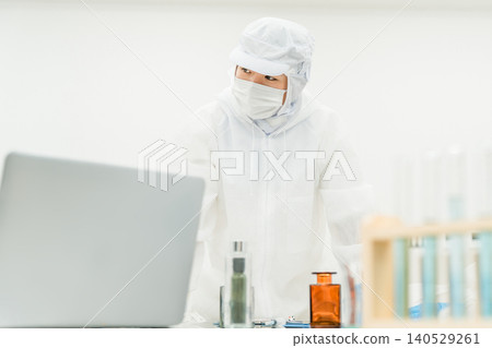 Staff wearing clean suits developing drugs at a pharmaceutical factory or pharmaceutical company Staff wearing clean suits developing drugs at a pharmaceutical factory or pharmaceutical company 140529261