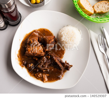 Rabbit stewed in wine sauce with spices in Aragonese style Rabbit stewed in wine sauce with spices in Aragonese style 140529307