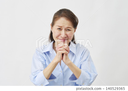 Elderly woman pleading on white background, looking at camera Elderly woman pleading on white background, looking at camera 140529365
