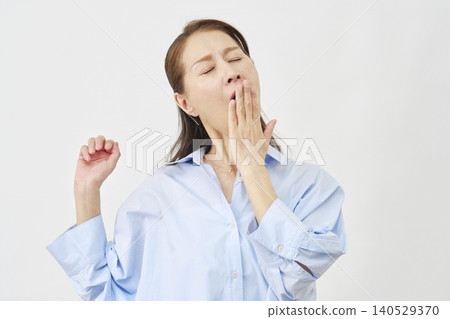 Elderly woman yawning on white background Elderly woman yawning on white background 140529370