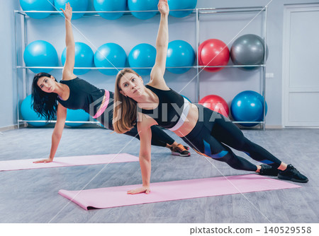 Young fitness women with blue fitballs. Crossfit training. Young fitness women with blue fitballs. Crossfit training. 140529558