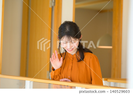 Japanese woman looking down from the connecting corridor 140529603