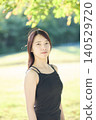 A female dancer in her twenties standing in an autumn park. 140529720