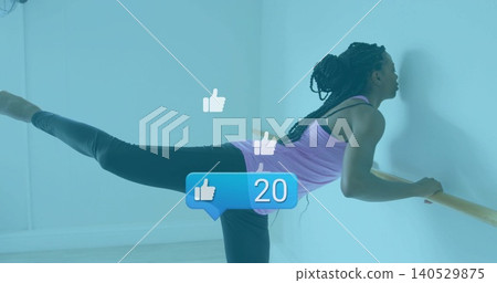Practicing woman in purple tank, black leggings holding barre in pale studio corner, with 20 icons Practicing woman in purple tank, black leggings holding barre in pale studio corner, with 20 icons 140529875