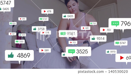 Tying woman wearing pink top and gray leggings on bed in bedroom, showing sneakers, social icons Tying woman wearing pink top and gray leggings on bed in bedroom, showing sneakers, social icons 140530020