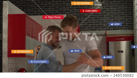 Dancing two men embracing in kitchen wearing denim shirt, patterned T-shirt, red cabinets, overlays Dancing two men embracing in kitchen wearing denim shirt, patterned T-shirt, red cabinets, overlays 140530082