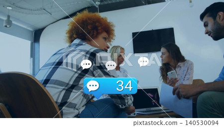 Talking team in business attire leaning around laptop in office holding phone, paper, chat badge 34 Talking team in business attire leaning around laptop in office holding phone, paper, chat badge 34 140530094