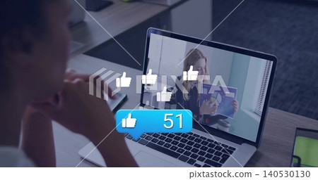 Viewing viewer in casual top at desk viewing laptop host wearing blouse holding chart thumbs-up 51 Viewing viewer in casual top at desk viewing laptop host wearing blouse holding chart thumbs-up 51 140530130