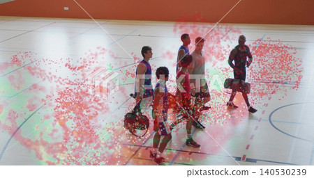 Walking six men in jerseys and shorts, with duffel bags across gym court markings, confetti overlay Walking six men in jerseys and shorts, with duffel bags across gym court markings, confetti overlay 140530239