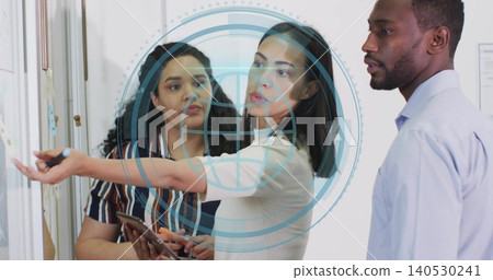 Pointing woman explaining at office glass board, man in blue shirt listening, tablet, AR overlay Pointing woman explaining at office glass board, man in blue shirt listening, tablet, AR overlay 140530241
